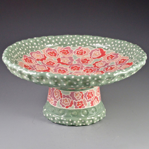 ceramic cake plate with painted green and red details
