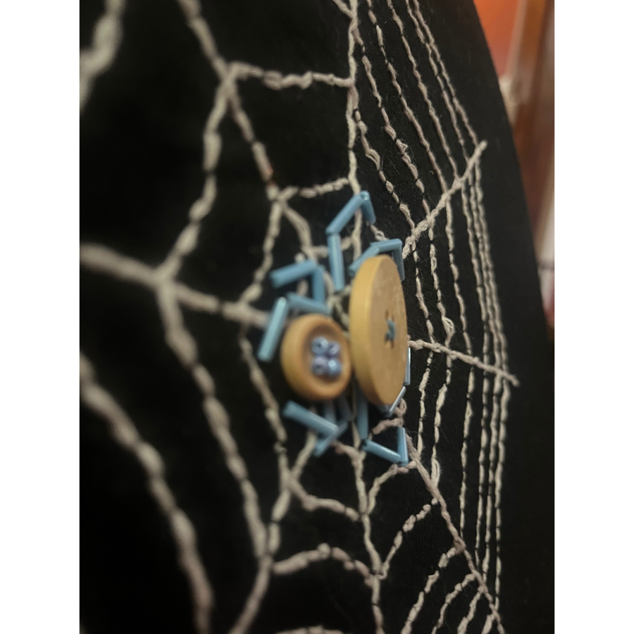 Fabric spiderweb with a button spider