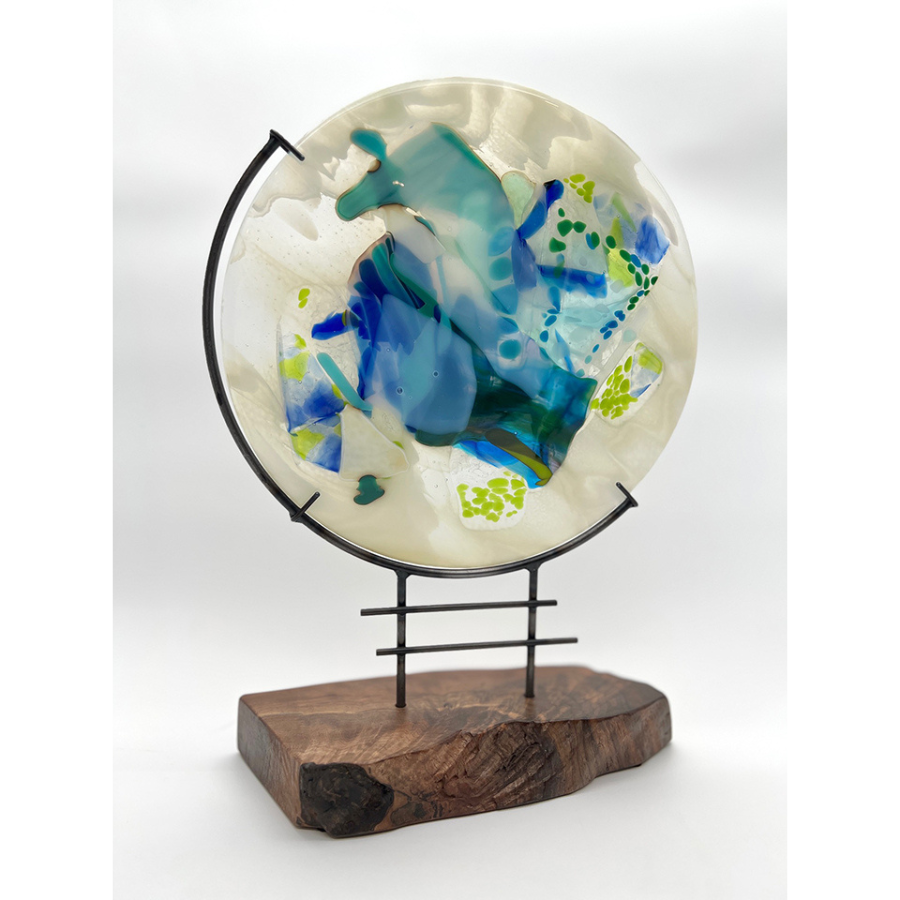 circular sculpture with a mix of materials like glass, metal and wood
