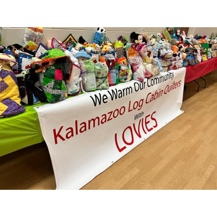 Table full of colorful quilted blankets