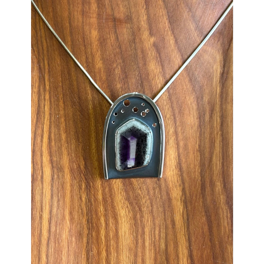 Close up of a metal necklace pendant