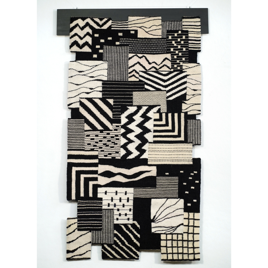 Black and white woven textile with different patterns and square shapes